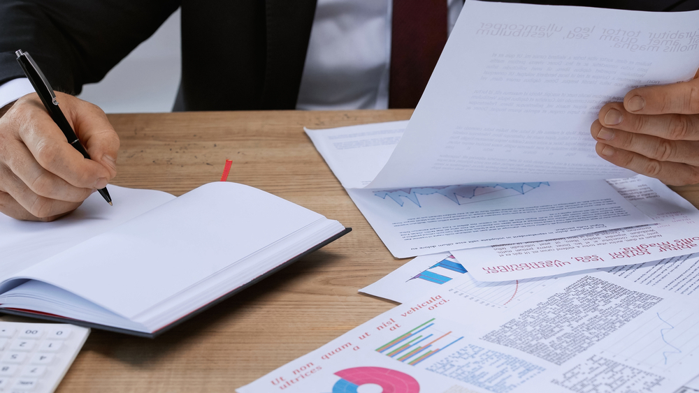 Man looking through papers and making notes