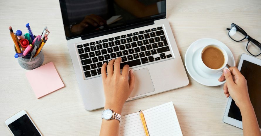 A woman works at a laptop